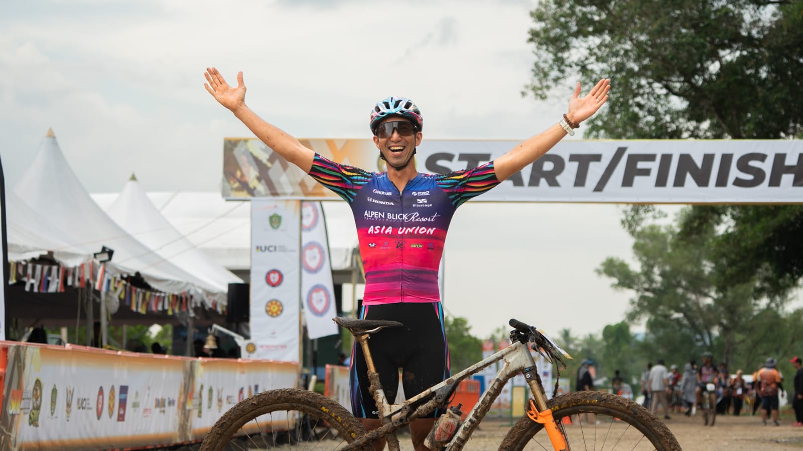Mountain bike racer celebrating at the finish line.